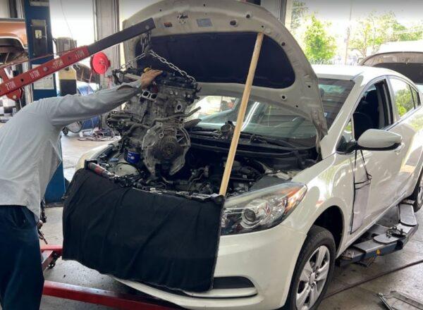 an engine getting replaced in a white car